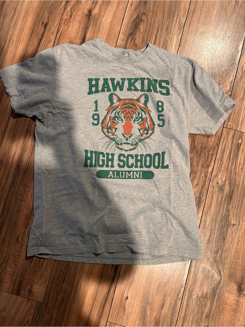 Netflix Heather Gray T-Shirt with Green & Orange Hawkins High Tiger Graphic